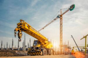 mobile crane on a road and tower crane in construction site