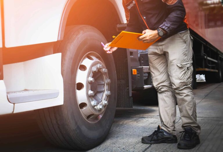 auto mechanic is checking the truck's safety maintenance checkli